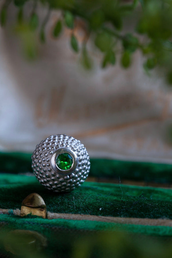 A special birthstone pendant for January – its centrepiece is a tactile textured ball with a glistening Green Garnet at the base