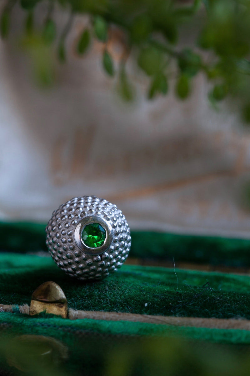 A special birthstone pendant for January – its centrepiece is a tactile textured ball with a glistening Green Garnet at the base