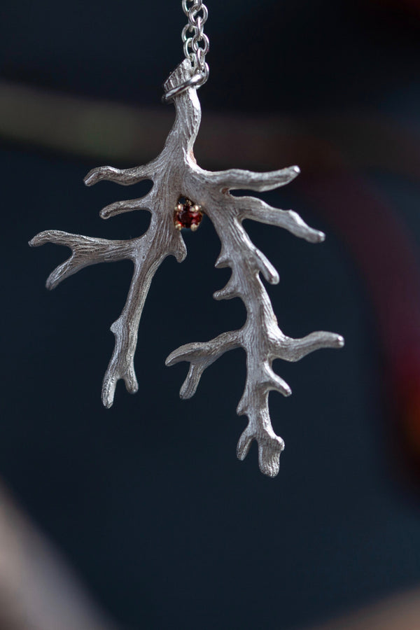 My unusual branch pendant set with a Red Garnet January's birthstone hangs from a delicate trace chain 