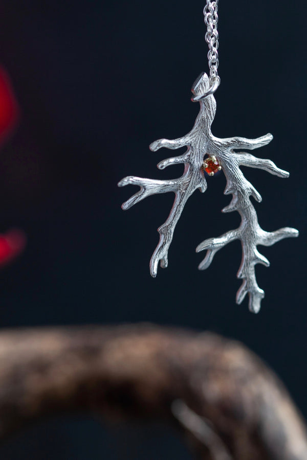 My unusual branch pendant set with a Ruby July's birthstone hangs from a delicate trace chain