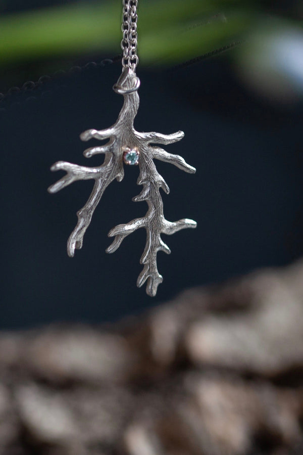 My branch pendant is set with March's birthstone Aquamarine hangs from a delicate trace chain 