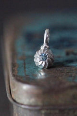 A delicate swirling gemstone charm – choose an Aquamarine for your March birthday. 