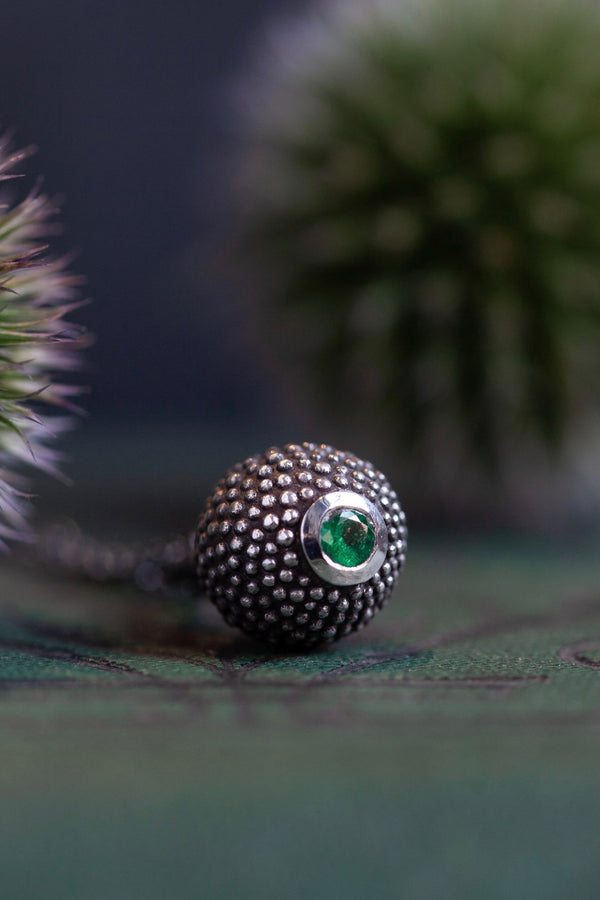 A special May birthstone pendant in oxidised silver – a tactile textured ball with a glistening Emerald at the base