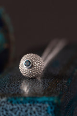 A special birthstone pendant for November – a tactile textured ball with a glistening London Blue Topaz at the base