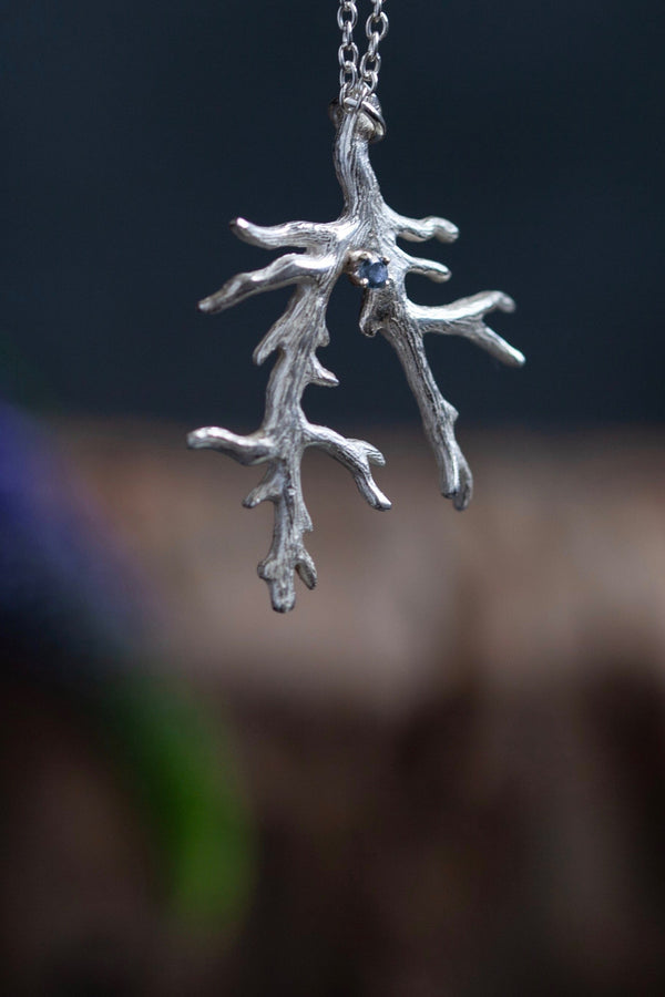 My unusual branch pendant, with a London Blue Topaz November's birthstone, on a delicate trace chain