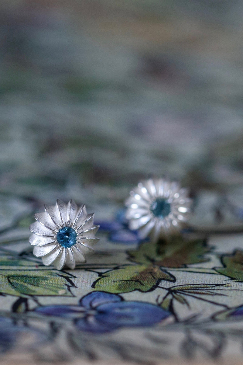 My November Swiss Blue Topaz Birthstone Satsuma Studs are subtly striped and set with gemstones