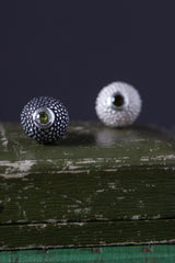 A pair of birthstone pendants for October – a tactile textured ball with a glistening Green Tourmaline at the base