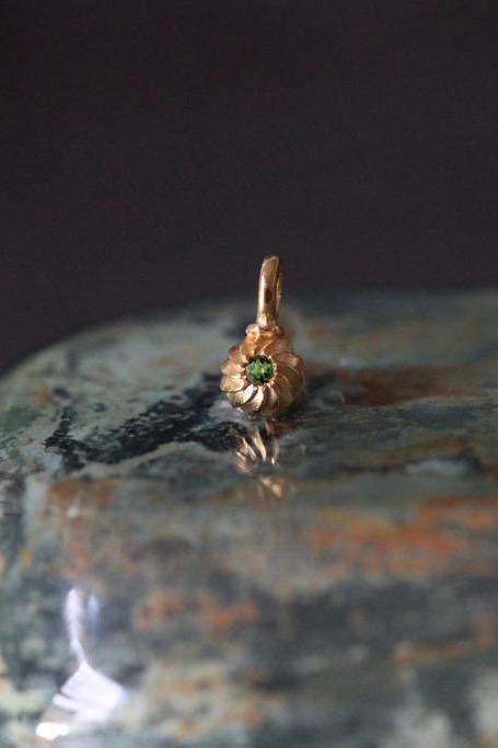 A delicate swirling gemstone charm – choose a green Tourmaline for your October birthday. 