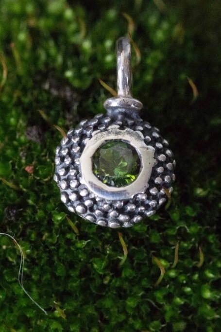 An elegant charm with a bobbled pattern – choose a green Tourmaline for your October birthday