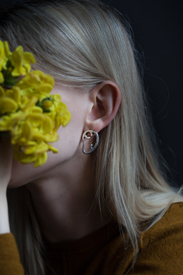 Unique, statement earrings inspired by the curves of an angel’s wing.