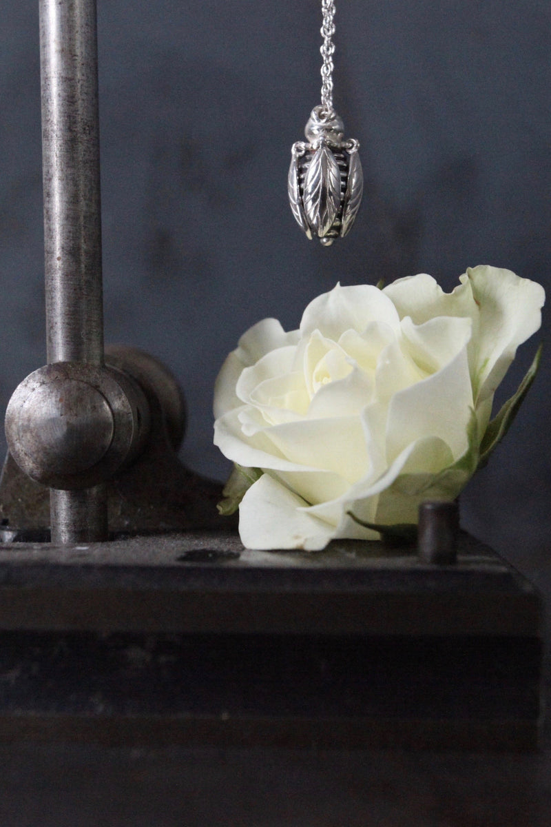 Close up of my Tiny Bee necklace features a chunky pendant on a fine chain 