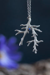 My branch pendant with a Sapphire, September's birthstone, on a delicate trace chain can be worn at two lengths