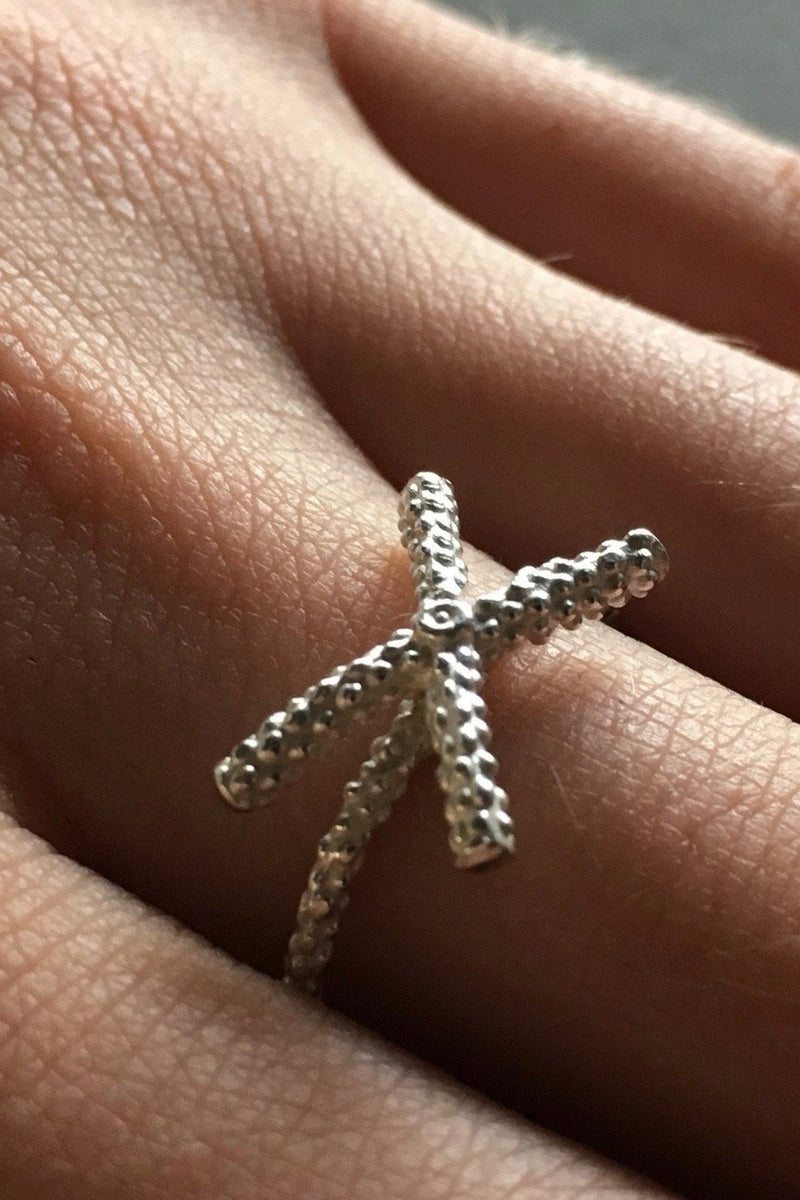 My Kiss Cross Ring is formed from a cross or kiss mounted on a simple band worn in silver