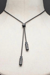 An elegant tassel pendant in oxidised silver on snake chain with two beads that customise how the necklace falls