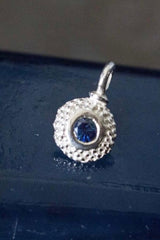 An elegant charm with a bobbled pattern – choose a Sapphire for your September birthday