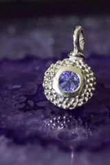 An elegant charm with a bobbled pattern – choose a Tanzanite for your December birthday